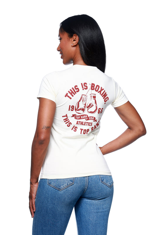 Woman wearing a natural-colored crew neck t-shirt with the Top Rank logo on the front and 'This is Boxing, This is Top Rank' on the back